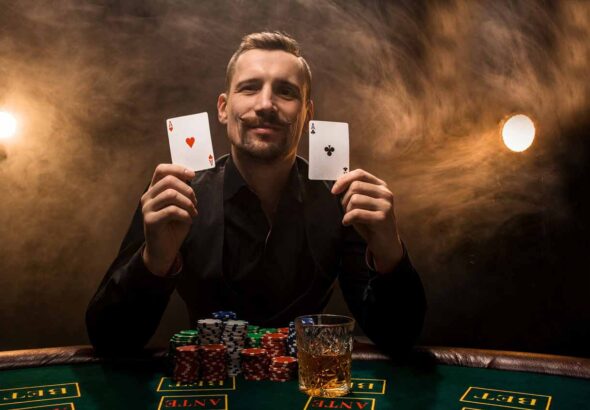 Man is playing poker with a cigar and a whiskey, a man show two